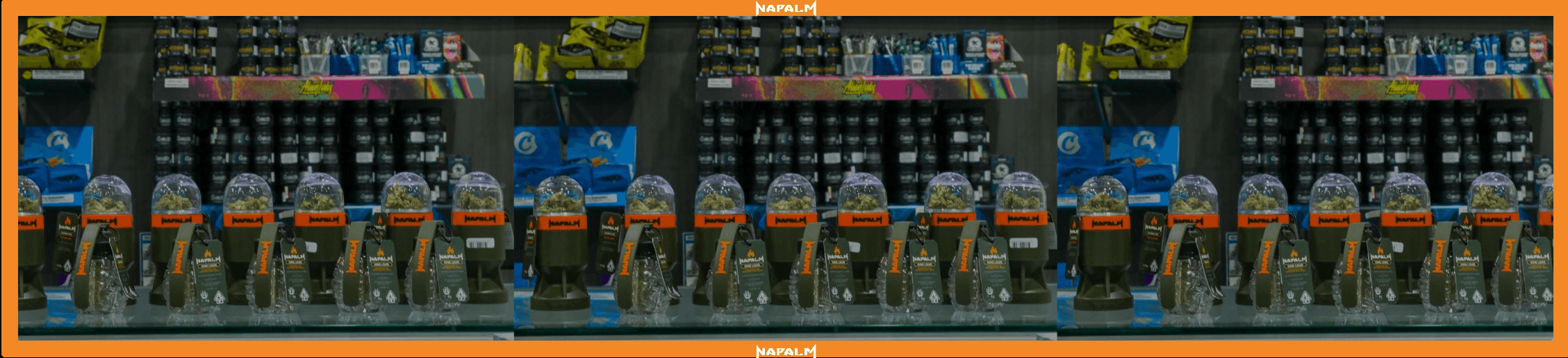 Grenade-shaped jars of Napalm cannabis flower lined up on a dispensary display shelf.
